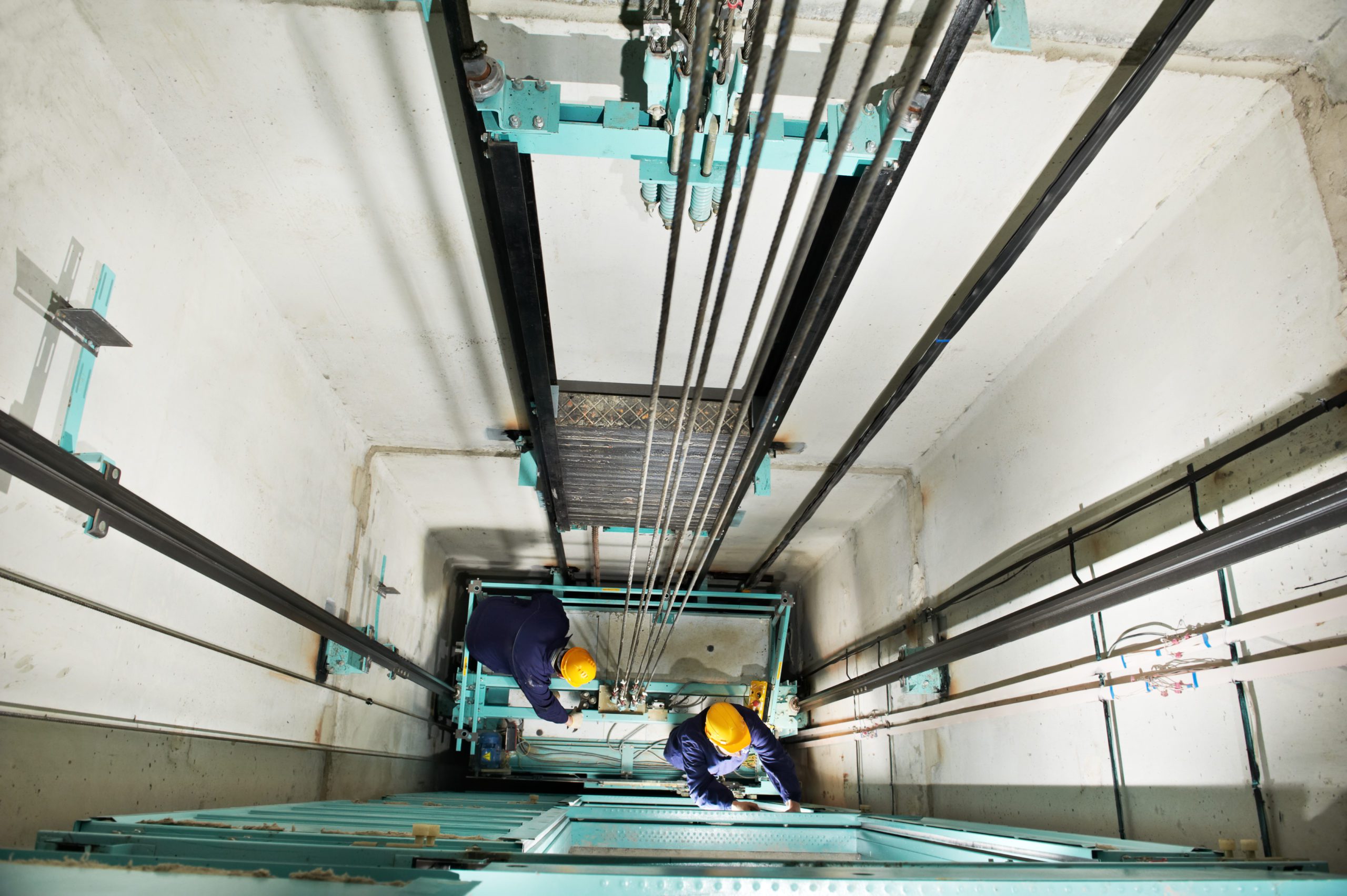 Two Machinist Adjusting Lift of Elevator